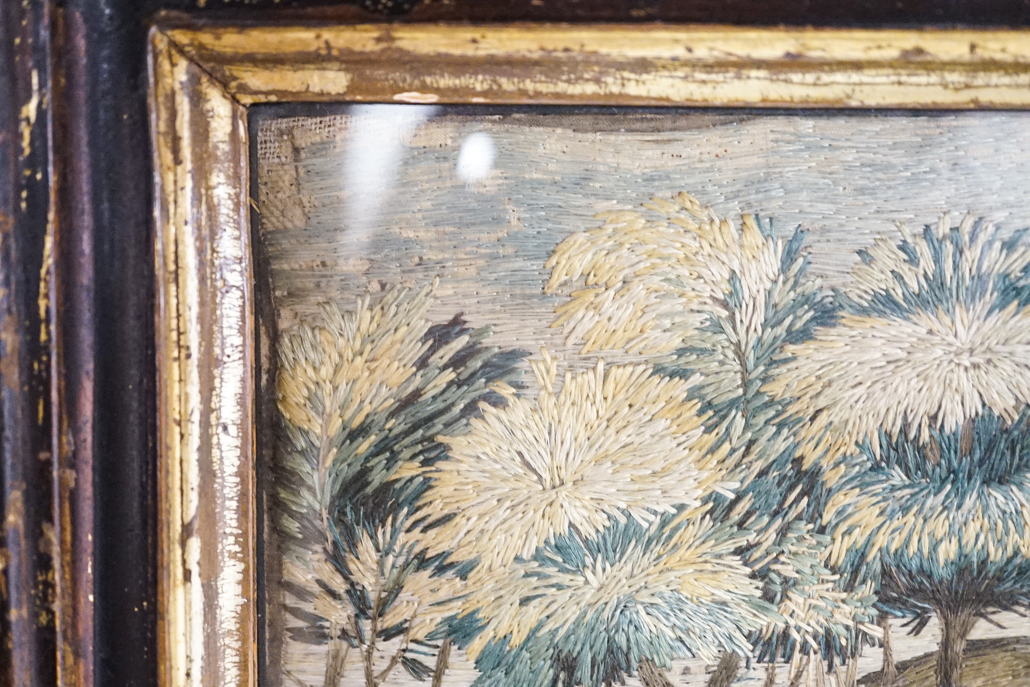 A pair of 18th century wool and silkwork pictures in ebonised frames, 26 cms high x 22 cms wide.